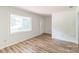 Bright living room featuring wood-look floors and a large window at 711 E John St, Matthews, NC 28105
