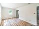 A spacious living room featuring modern wood-look floors and neutral walls at 711 E John St, Matthews, NC 28105