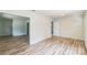 A spacious living room featuring modern wood-look floors and neutral walls at 711 E John St, Matthews, NC 28105