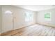 Bright living room features wood-look flooring and large windows at 711 E John St, Matthews, NC 28105