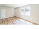 A bright living room with modern wood-look floors and a large window at 711 E John St, Matthews, NC 28105