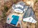 Beautiful aerial view of the backyard, in-ground pool with a cover, deck and mature trees at 8384 Blades Trl, Denver, NC 28037
