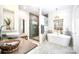 Luxurious bathroom with soaking tub, glass shower, modern fixtures, vanity, and marble tile flooring at 8384 Blades Trl, Denver, NC 28037