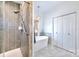 Modern bathroom with standalone tub, glass shower, white cabinets and marble tile flooring at 8384 Blades Trl, Denver, NC 28037