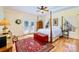 This spacious bedroom has hardwood floors, a ceiling fan, and French doors leading to a private patio at 8384 Blades Trl, Denver, NC 28037