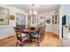 Traditional dining room with hardwood floors, decorative molding, chandelier, and access to a kitchen at 8384 Blades Trl, Denver, NC 28037