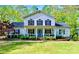 Charming two-story home with a inviting front porch and well-manicured lawn and landscaping at 8384 Blades Trl, Denver, NC 28037