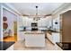 Kitchen features white cabinets, granite countertops, stainless steel appliances, and tile floor with a center island at 8384 Blades Trl, Denver, NC 28037