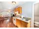 Efficient kitchenette with cabinets, a stove, and a sink, providing a convenient cooking space at 8384 Blades Trl, Denver, NC 28037