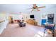 Spacious living room with neutral carpet, large ceiling fan, and ample space for entertaining and relaxation at 8384 Blades Trl, Denver, NC 28037