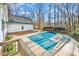 Backyard pool with a partial cover, deck, surrounded by mature trees providing privacy and space for outdoor enjoyment at 8384 Blades Trl, Denver, NC 28037
