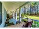Relax on the comfortable covered porch overlooking the wooded backyard at 8384 Blades Trl, Denver, NC 28037