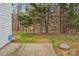 View of the backyard featuring green grass, woods, and a concrete patio at 9160 Exbury Ct, Charlotte, NC 28269