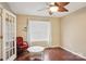 Cozy bedroom features hardwood floors, a ceiling fan, and natural light from the window at 9160 Exbury Ct, Charlotte, NC 28269