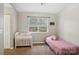 This bedroom has a cot, a bed, and a window that lets in natural light at 9160 Exbury Ct, Charlotte, NC 28269