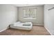 Neutral bedroom with a bed frame on the floor near a window at 9160 Exbury Ct, Charlotte, NC 28269