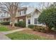 Charming two-story townhome featuring brick accents, vinyl siding, and mature landscaping at 9160 Exbury Ct, Charlotte, NC 28269