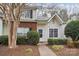 Charming two-story townhome featuring brick accents, vinyl siding, and mature landscaping at 9160 Exbury Ct, Charlotte, NC 28269
