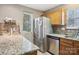 Bright kitchen features stainless steel refrigerator, granite countertops, and ample cabinet space at 9160 Exbury Ct, Charlotte, NC 28269