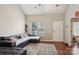 Bright living room with high ceilings, wood floors, and abundant natural light at 9160 Exbury Ct, Charlotte, NC 28269