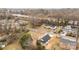 An aerial view of a home in its neighborhood, near a rail line, with a concrete driveway at 923 Cedar St, Salisbury, NC 28144
