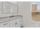 Bathroom featuring a vanity with granite countertop and a framed mirror above it at 923 Cedar St, Salisbury, NC 28144