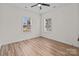 Cozy bedroom boasts two windows, neutral walls, and wood-look flooring at 923 Cedar St, Salisbury, NC 28144