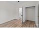 A bright bedroom with a closet and an open door with wood-look flooring at 923 Cedar St, Salisbury, NC 28144