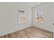Bright bedroom with two windows allowing ample natural light and wood look flooring at 923 Cedar St, Salisbury, NC 28144