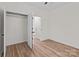 Light-filled bedroom with a closet and door, enhanced by elegant wood-look flooring at 923 Cedar St, Salisbury, NC 28144