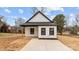 Charming home featuring a concrete driveway, minimalist landscaping, and a modern black and white design at 923 Cedar St, Salisbury, NC 28144