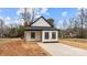 Charming home featuring a concrete driveway, minimalist landscaping, and a modern black and white design at 923 Cedar St, Salisbury, NC 28144