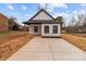 Charming home featuring a concrete driveway, minimalist landscaping, and a modern black and white design at 923 Cedar St, Salisbury, NC 28144