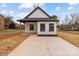 Charming home featuring a concrete driveway, minimalist landscaping, and a modern black and white design at 923 Cedar St, Salisbury, NC 28144