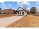 Charming home featuring a concrete driveway, minimalist landscaping, and a modern black and white design at 923 Cedar St, Salisbury, NC 28144