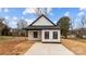 Charming exterior of a modern home featuring black trim, white siding, and fresh landscaping at 923 Cedar St, Salisbury, NC 28144