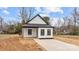 Charming exterior of a modern home featuring black trim, white siding, and fresh landscaping at 923 Cedar St, Salisbury, NC 28144