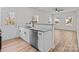 Open kitchen with stainless steel dishwasher, granite countertops, and breakfast bar overlooking the living area at 923 Cedar St, Salisbury, NC 28144