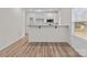 Bright, open-concept kitchen with white cabinetry, stainless steel appliances, and a breakfast bar at 923 Cedar St, Salisbury, NC 28144