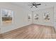 Bright living room with multiple windows, wood-look floors, and neutral paint at 923 Cedar St, Salisbury, NC 28144