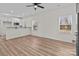 Bright living room features wood-look floors, two windows, and opens to kitchen with breakfast bar at 923 Cedar St, Salisbury, NC 28144