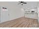 Bright living room shows open layout, wood-look floors, and leads to an entry door at 923 Cedar St, Salisbury, NC 28144