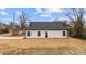 Rear exterior of a home featuring white siding, black trim, and a dark roof at 923 Cedar St, Salisbury, NC 28144