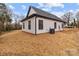 Rear exterior of home with an air conditioning unit and white siding, showcasing its design at 923 Cedar St, Salisbury, NC 28144