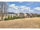 View of backyard, featuring neighboring homes and some landscaping at 1035 Ivey Ct, Fort Mill, SC 29707