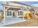 Spacious backyard featuring a covered patio and playset, perfect for outdoor entertaining and Gathering fun at 1035 Ivey Ct, Fort Mill, SC 29707