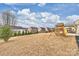 Large backyard featuring a playset, and ample space for outdoor activities with neighbors homes visible at 1035 Ivey Ct, Fort Mill, SC 29707