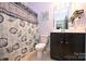 Charming bathroom with a seashell-themed shower curtain and vanity, bringing a touch of coastal style at 1035 Ivey Ct, Fort Mill, SC 29707