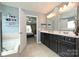 Bright bathroom with double sinks, a soaking tub, and an open doorway, perfect for relaxation and modern living at 1035 Ivey Ct, Fort Mill, SC 29707