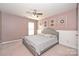 Stylish bedroom featuring a bed, artwork, a ceiling fan, and a window, offering a modern design at 1035 Ivey Ct, Fort Mill, SC 29707